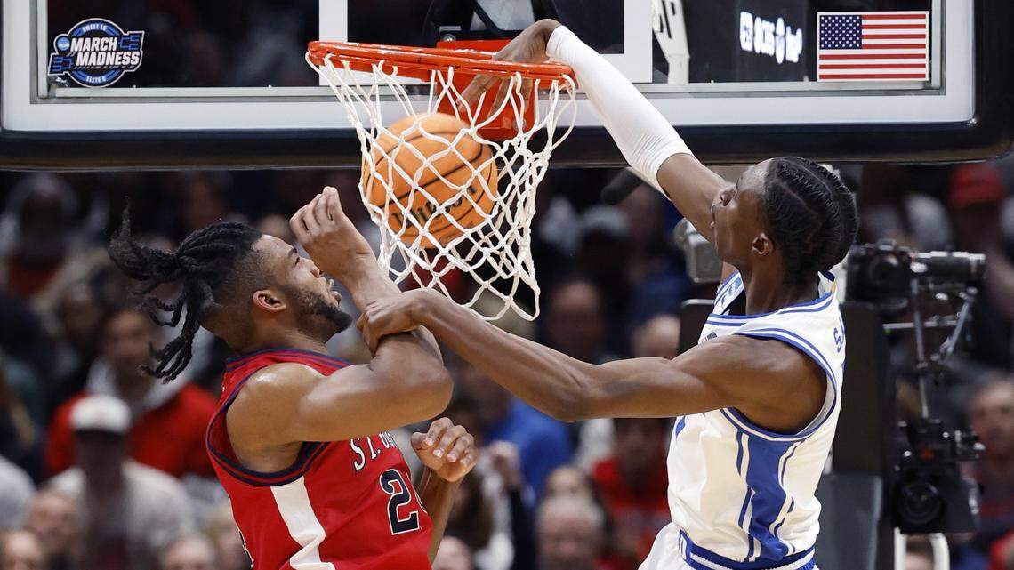Duke’s Dame Sarr (7) slams in two as St. John's Zuby Ejiofor (24) defends during Duke’s game against St. John’s in the 2026 NCAA Sweet 16.