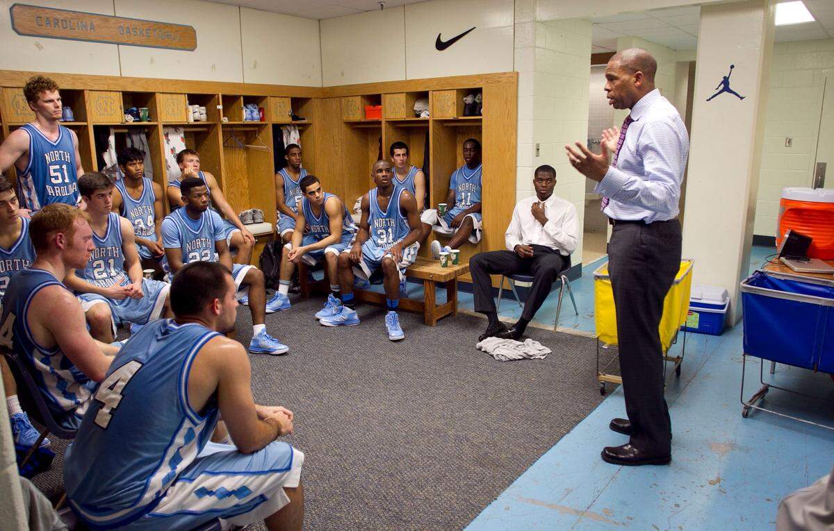 UNC JV coach Hubert Davis talks with his team in the locker room prior to their first game against Mt. Olive at the Smith Center in Chapel Hill, N.C. on November 11, 2013.