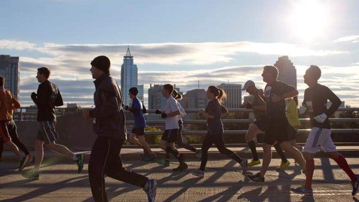 Runners cross the Boylan Street bridge during the Raleigh City of Oaks Marathon in 2014 in Raleigh, N.C. The annual event gives runners views of Raleigh’s skyline.