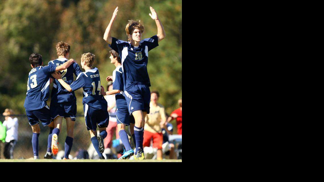 Jack Hensely (12) of St. David’s School is congratulated by teammates Matoe Cornejo (13), Matthew McLaughlin (14) and Harris Wilson (10) after scoring in a  1-0 victory Saturday over Gaston Day in the NCISAA 2A boys soccer state championship game in Raleigh.
