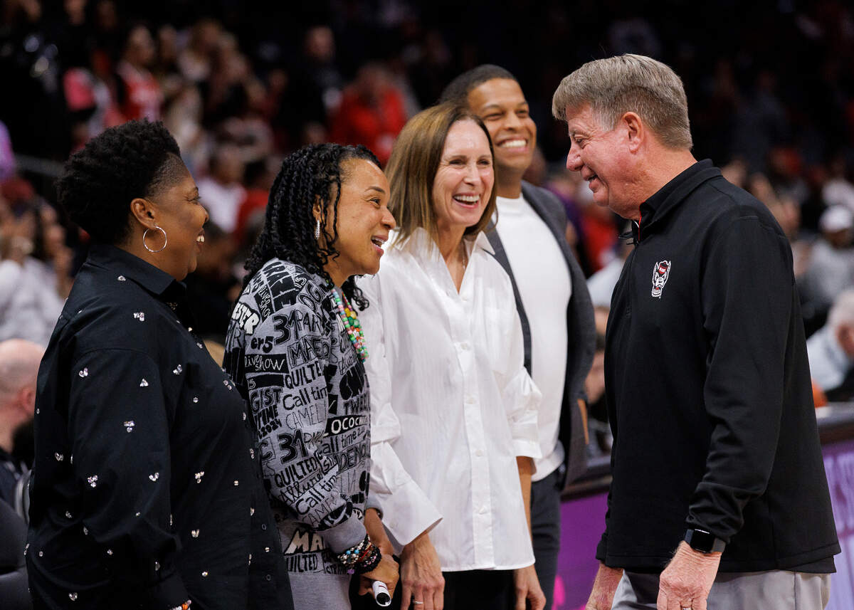 N.C. State head coach Wes Moore greets South Carolina head coach Dawn Staley prior to the Wolfpack’s game on Sunday, Nov. 10, 2024, at Spectrum Center in Charlotte, N.C.