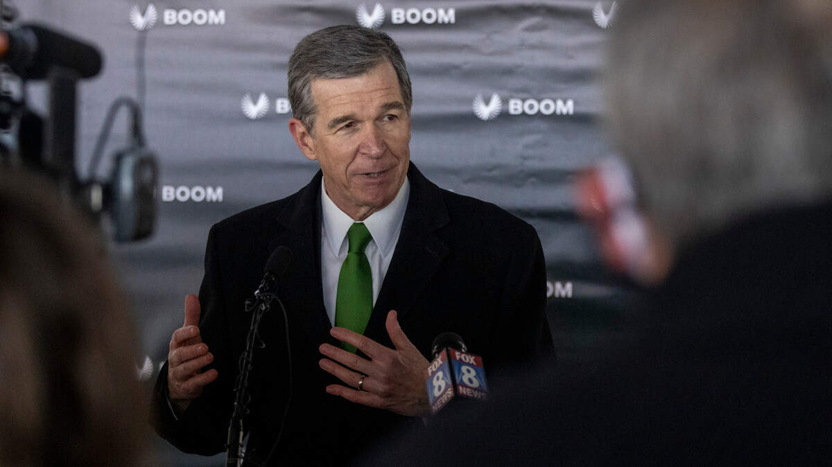 Gov. Roy Cooper speaks with reporters following a press conference Wednesday, Jan. 26, 2022 at Greensboro’s Piedmont Triad International announcing Boom Supersonic’s plans to build a $500 million “flagship” production facility at the airport that is expected to create more than 1,750 jobs.