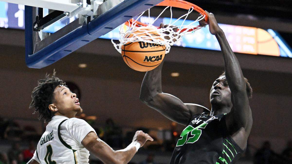 Utah Valley Wolverines center Aziz Bandaogo (55) dunks the ball against UAB Blazers guard Eric Gaines (4) in the first half at Orleans Arena.