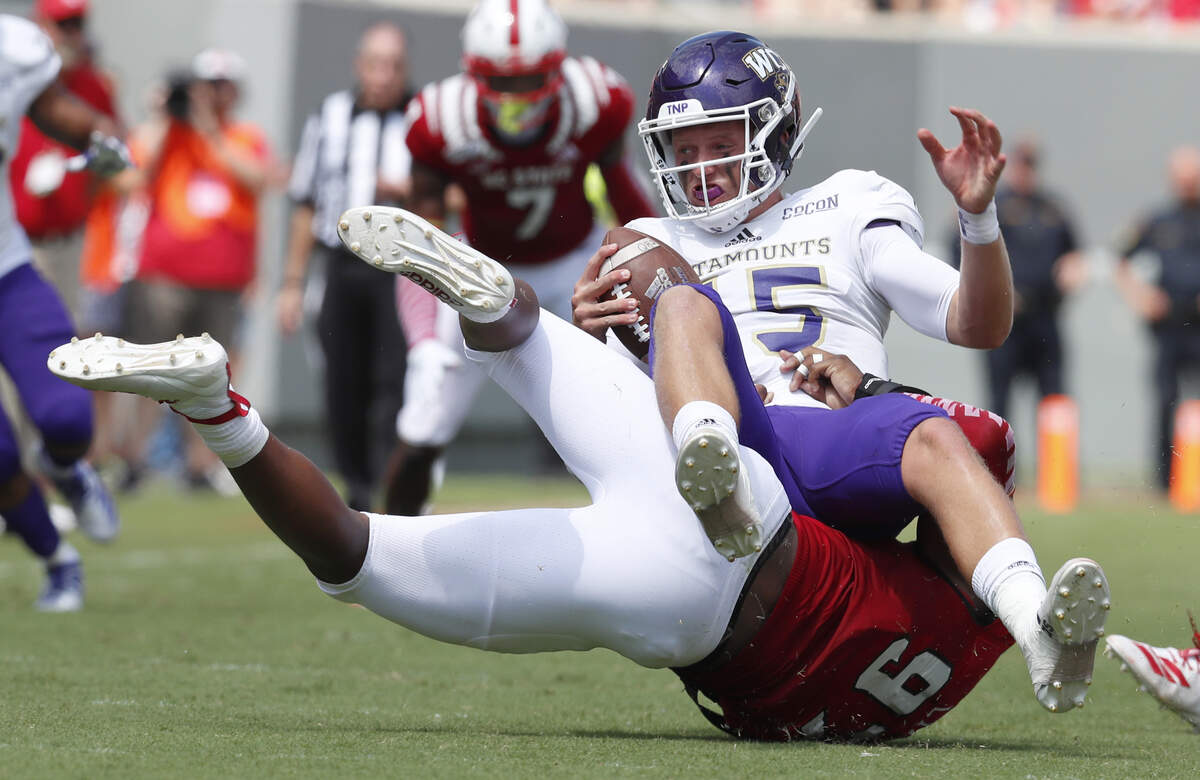 N.C. State defensive end Xavier Lyas (97) sacks Western Carolina quarterback Will Jones (15) during the first half of N.C. State’s game against Western Carolina at Carter-Finley Stadium in Raleigh, N.C., Saturday, Sept. 7, 2019.