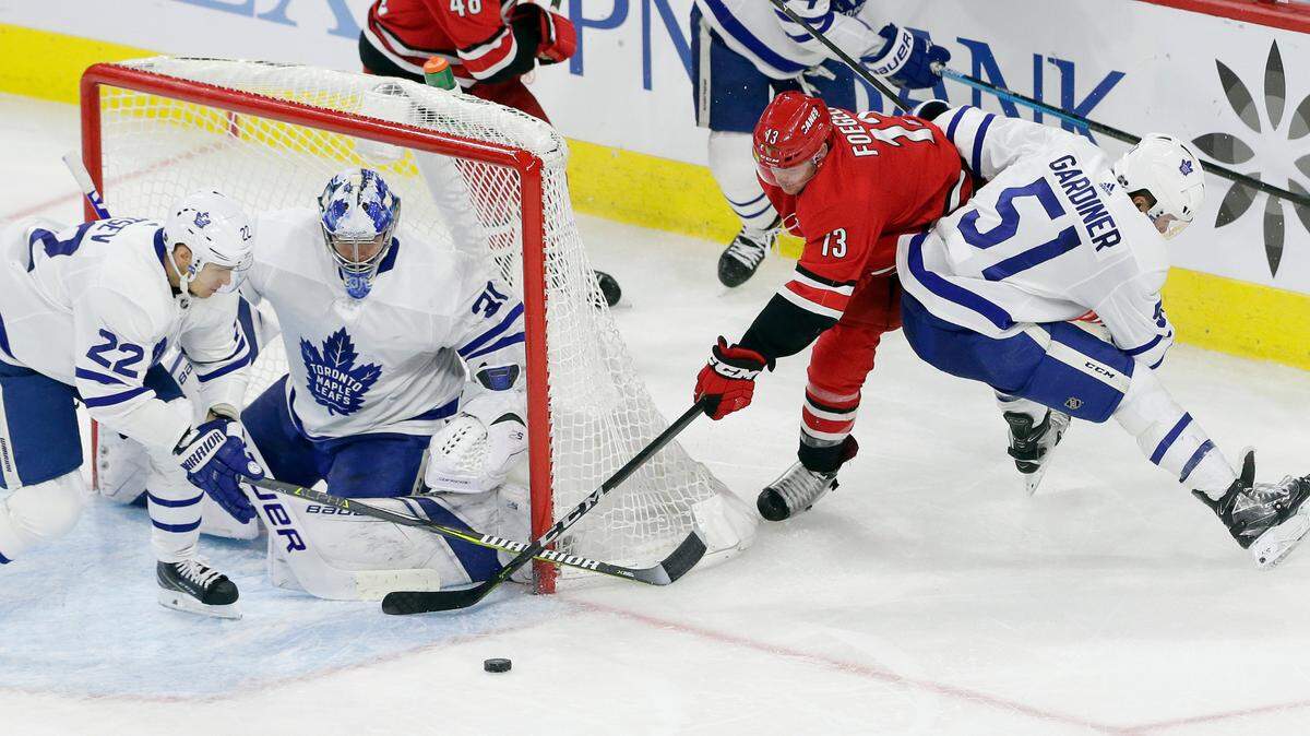Toronto Maple Leafs’ Nikita Zaitsev (22), of Russia, Jake Gardiner (51) and goalie Frederik Andersen (31), of Denmark, defend the goal from Carolina Hurricanes’ Warren Foegele (13) during the third period of an NHL hockey game in Raleigh, N.C., Tuesday, Dec. 11, 2018. Toronto won 4-1. (AP Photo/Gerry Broome)