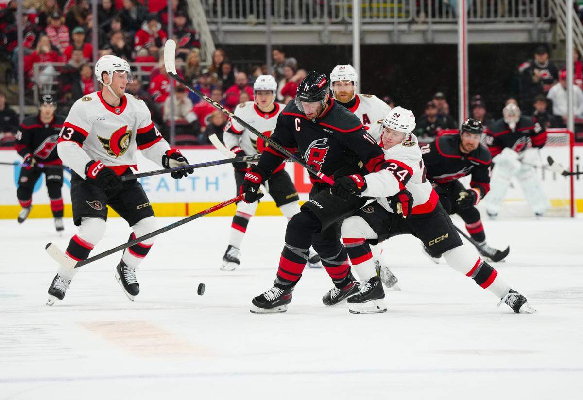 Carolina Hurricanes center Jordan Staal (11) battles for the puck against Ottawa Senators defenseman Jacob Bernard-Docker (24) during the first period at Lenovo Center.