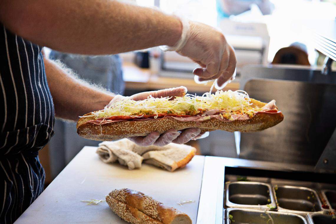 Ian Bracken makes an Italiano at Ideal’s Sandwich & Grocery in Durham on Thursday Sept. 23, 2021, during lunch.