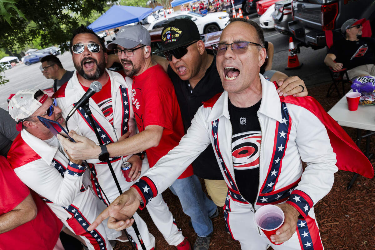 Matt Carden, (from right) a member of the CaneEvels fan group, sings alongside his buddies Jesse Sandoval, Ryan McCauley, Adam Averkamp and Donnie Robinson, in the parking lot outside the Lenovo Center on June 11, 2026, in Raleigh, North Carolina. The Carolina Hurricanes take on the Vegas Golden Knights for Game 5 of the Stanley Cup Final.
