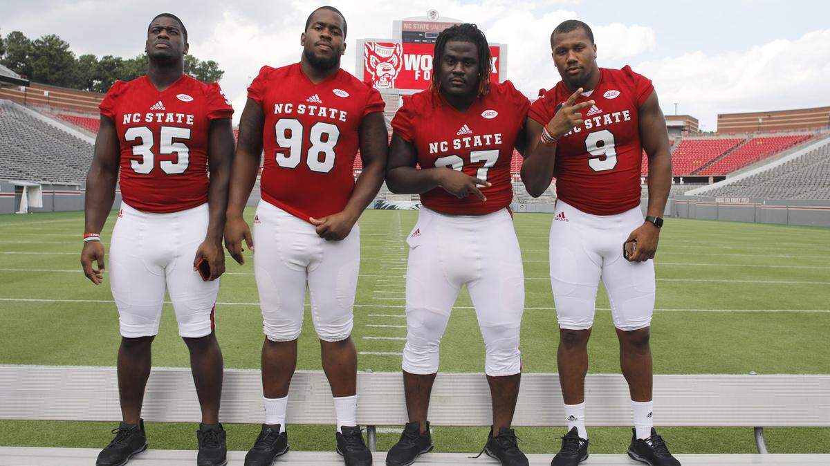 From left, N.C. State’s Kentavius Street (35), B.J. Hill (98), Justin Jones (27) and Bradley Chubb (9) pose before the defensive line photo is taken during N.C. State football’s media day at Carter-Finley Stadium in Raleigh, N.C., Sunday, August 6, 2017.