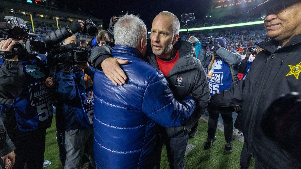 North Carolina coach Mack Brown congratulates N.C. State coach Dave Doeren following the Wolfpack’s 35-30 victory on Saturday, November 30, 2024 at Kenan Stadium in Chapel Hill, N.C.