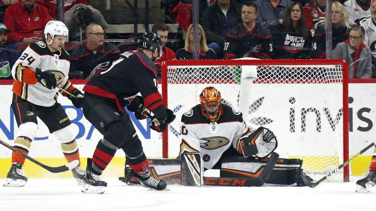 Anaheim Ducks goaltender Ryan Miller (30) blocks Carolina Hurricanes center Jordan Staal (11) while Ducks center Sam Steel (34) watches during the first period of an NHL hockey game in Raleigh, N.C., Friday, Jan. 17, 2020. (AP Photo/Gerry Broome)