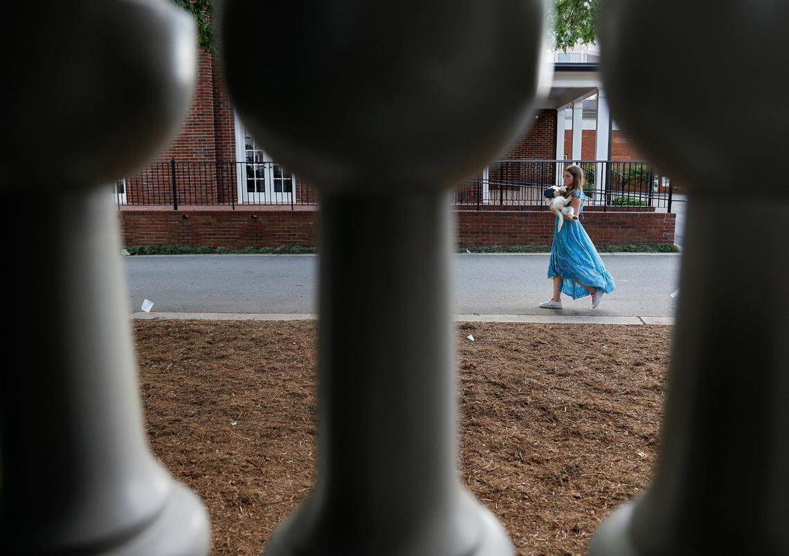 Melina Kuehn, 16, carries Clementine, her family’s English Cream Golden Retriever puppy, during a fundraising event for CASA, an affordable housing nonprofit, at the Andrews-Duncan House on Tuesday, May 16, 2023, in Raleigh, N.C.
