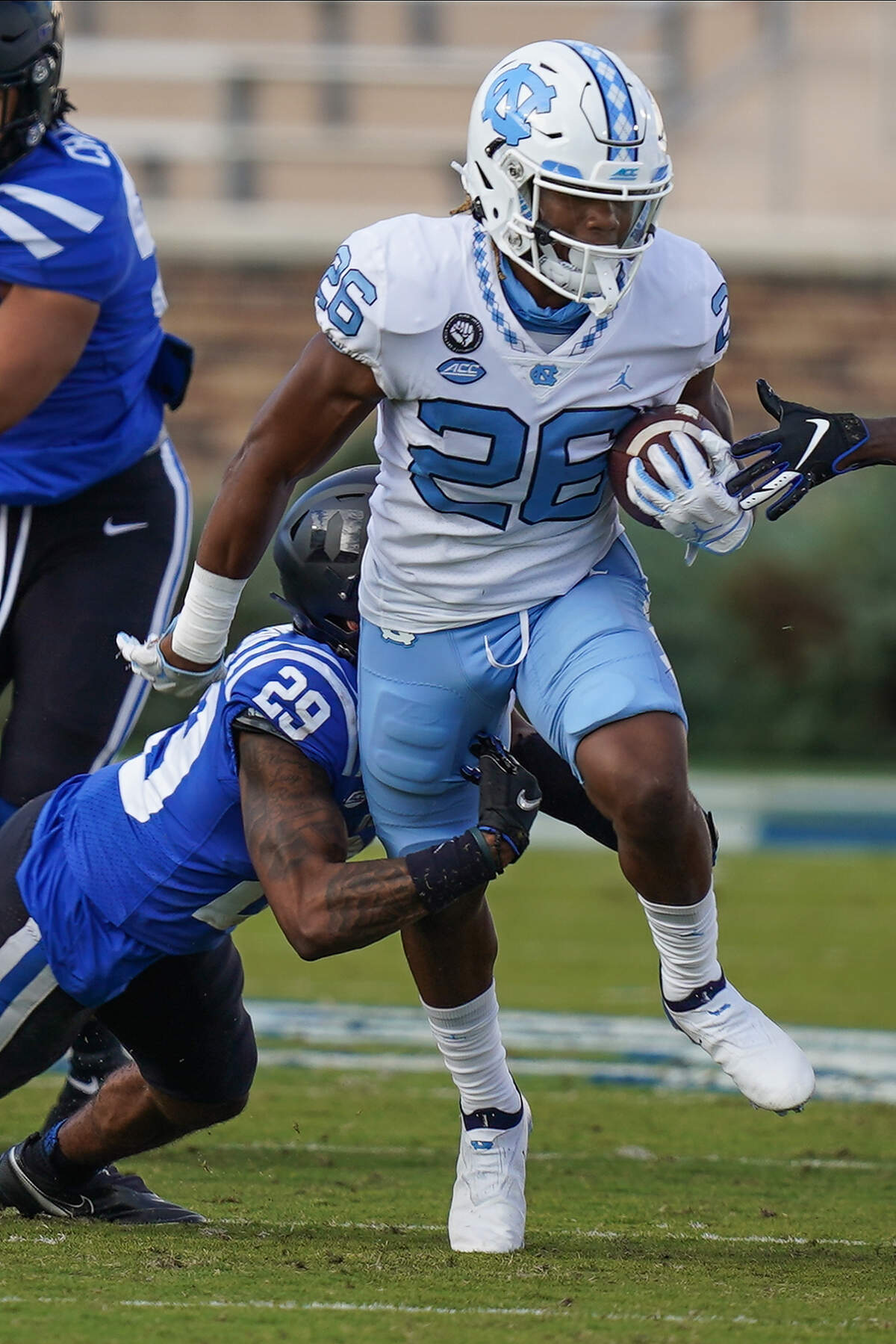 North Carolina Tar Heels running back D.J. Jones (26) runs past Duke Blue Devils safety Nate Thompson (29) during the second half at Wallace Wade Stadium. 