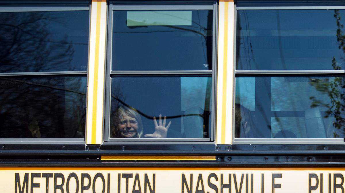 A child weeps while on the bus leaving The Covenant School following a mass shooting at the school in Nashville, Tenn., Monday, March 27, 2023.