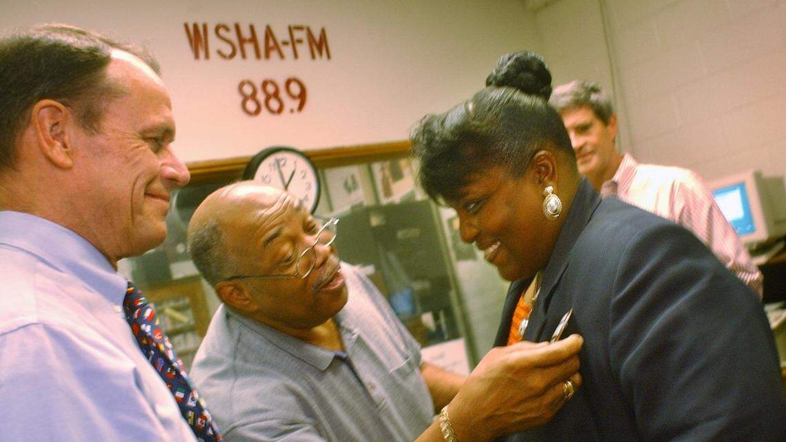 WSHA radio's "Traces of Faces and Paces" co-host Frank Roberts, center, checks out U. S. Senate candidate Cynthia Brown's campaign button in 2002, after Brown appeared as a guest on the show at Shaw University