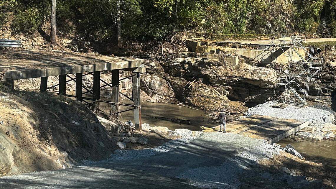Richard Russell stands on a temporary path where the Hungry River washed out the Big Hungry Road bridge in Henderson County, N.C. Russell is one of dozens of people who live in an area cut-off to traffic since the remnants of Hurricane Helene took out the bridge on Sept. 27, 2024.