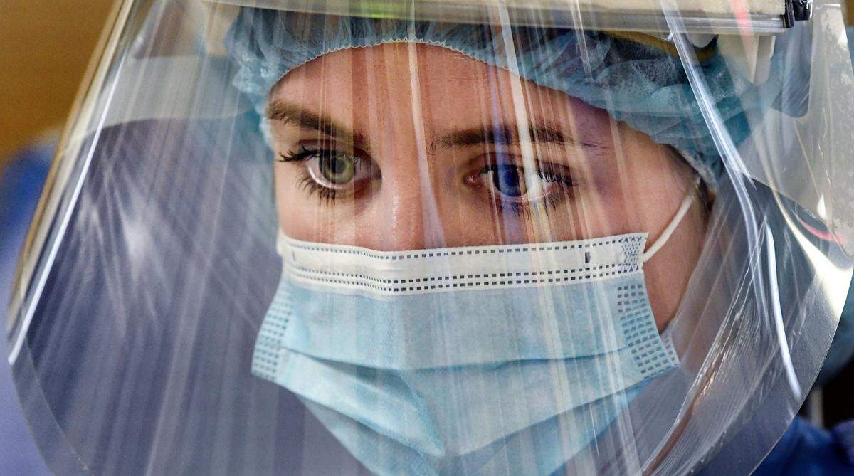 Katie Sessoms, RN, cares for COVID patients in the Medical Intensive Care Unit at UNC Hospital in Chapel Hill, N.C. Friday, Aug. 27, 2021.