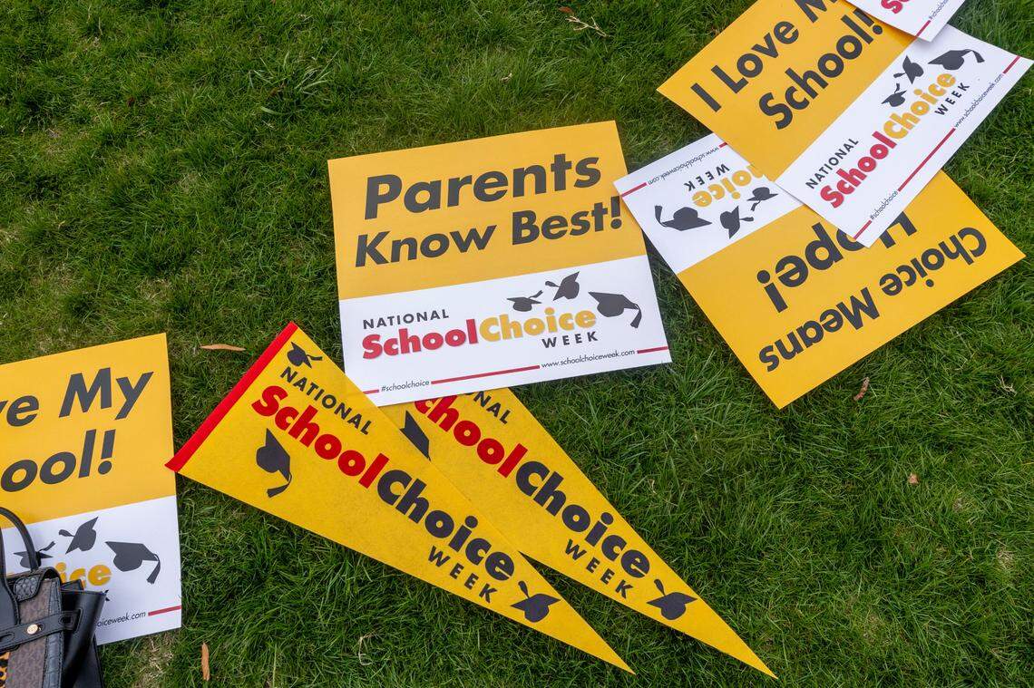 Signs lay in the grass during a rally celebrating National School Choice Week on Halifax Mall in front of the Legislative Building in Raleigh on Wednesday, Jan. 24, 2024.