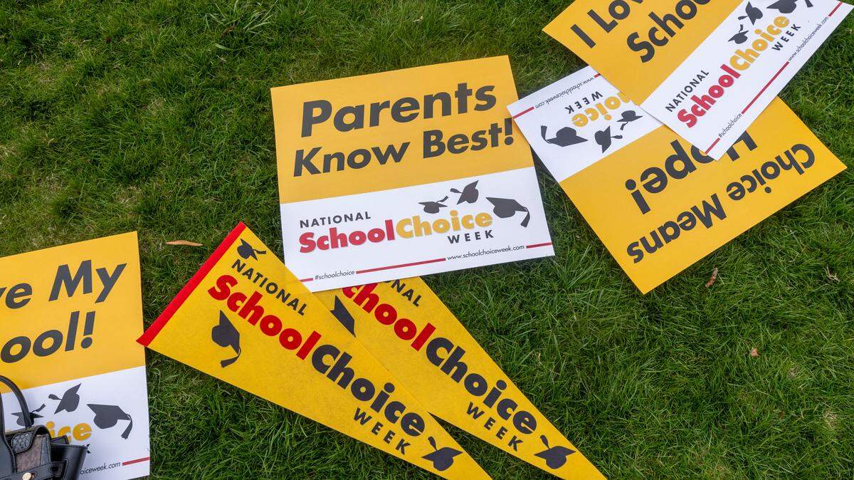 Signs lay in the grass during a rally Signs lay in the grass during a rally celebrating National School Choice Week on Halifax Mall in front of the Legislative Building in Raleigh on Wednesday, Jan. 24, 2024. New numbers show that NC’s voucher program now serves mostly middle and upper income students in some counties.