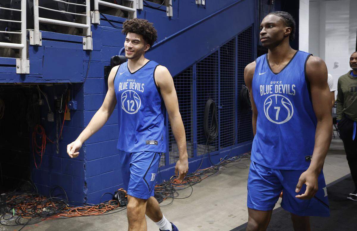 Duke’s Cameron Boozer (12) and Dame Sarr (7) walk onto the court before the Blue Devils’ practice at Capital One Arena in Washington, D.C., Thursday, March 26, 2026. The Blue Devils face St. John’s in the Sweet 16 of the NCAA Men’s Basketball East Regional Friday.
