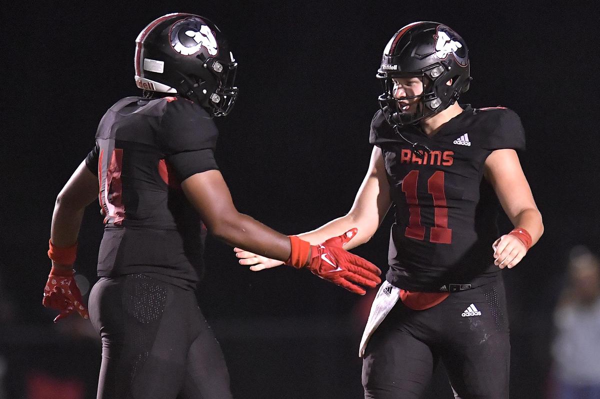 Rolesville quarterback Braden Atkinson (11) congratulates Davis Brown (14) after a play in the second half. The Rolesville Rams and the Butler Bulldogs met in a non-conference football game in Rolesville N.C. on August 18, 2023.