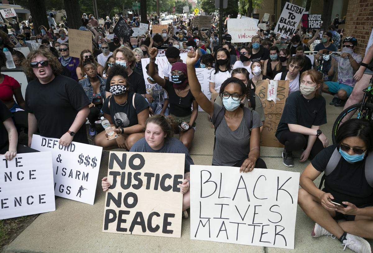 Protesters hold a rally outside the North Carolina GOP headquarters on Hillsborough Street on Tuesday, June 2, 2020 in Raleigh, N.C.