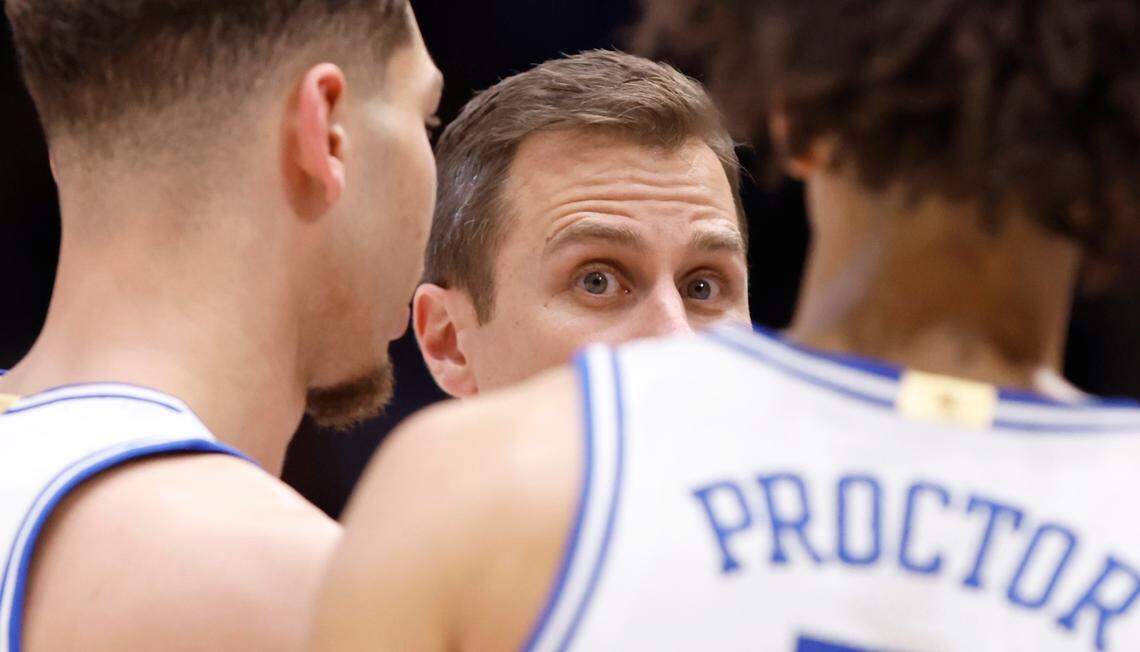 Duke head coach Jon Scheyer talks with Mason Gillis (18) and Tyrese Proctor (5) during a timeout in the second half of Duke’s 78-57 victory over Cal at Cameron Indoor Stadium in Durham, N.C., Wednesday, Feb. 12, 2025.