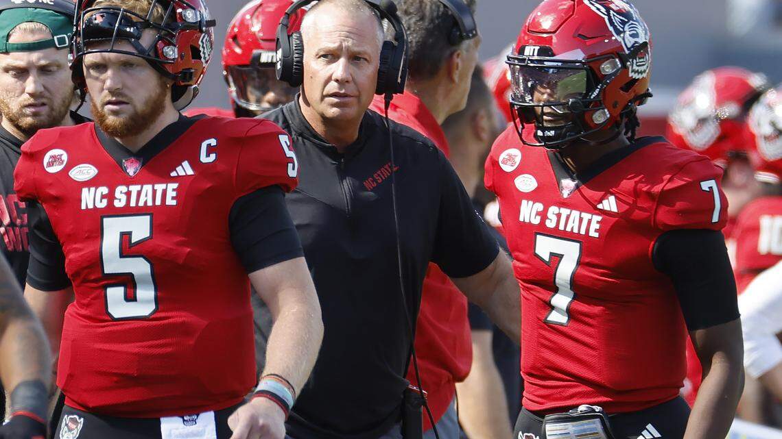 N.C. State head coach Dave Doeren talks with quarterback MJ Morris (7) after he threw an interception during the first half of N.C. State’s game against Marshall at Carter-Finley Stadium in Raleigh, N.C., Saturday, Oct. 7, 2023.