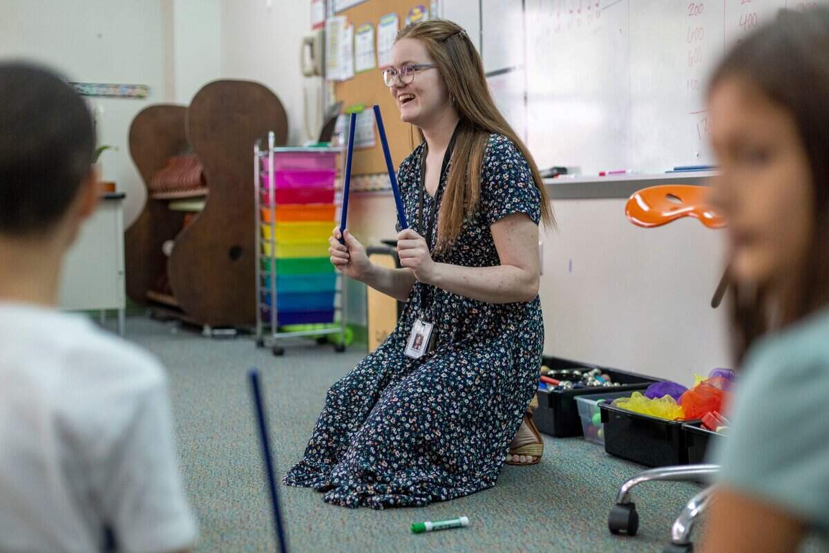 Liz Yardley, a recent college graduate has begun her teaching career at Sycamore Creek Elementary School. Yardley instructs a fifth grade class on how to read music and count beats using rhythm sticks on Tuesday, August 16, 2022 in Raleigh, N.C.