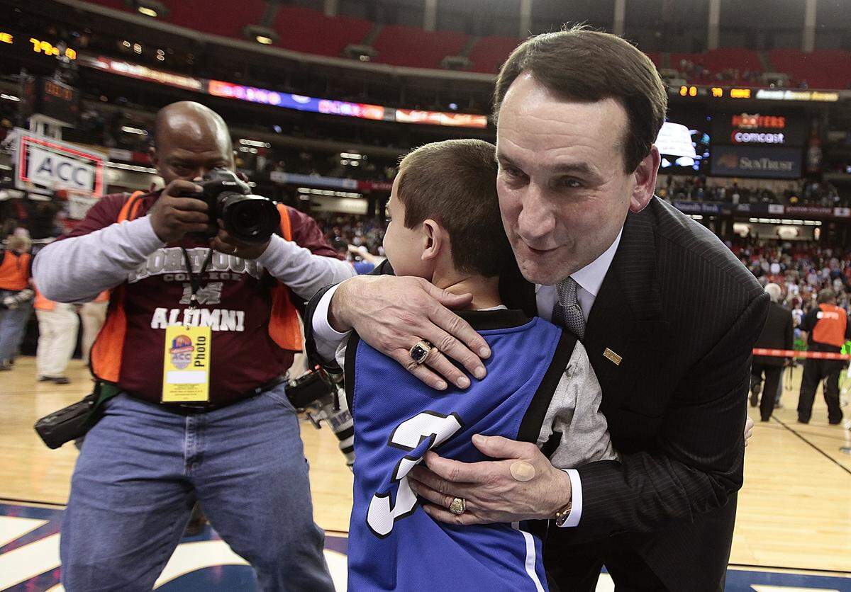 Duke head coach Mike Krzyzewski hugs his grandson Joey Savarino, 9, after the Blue Devils win the ACC tourney at the Georgia Dome in Atlanta,Ga. during the 2009 ACC Tournament finals.