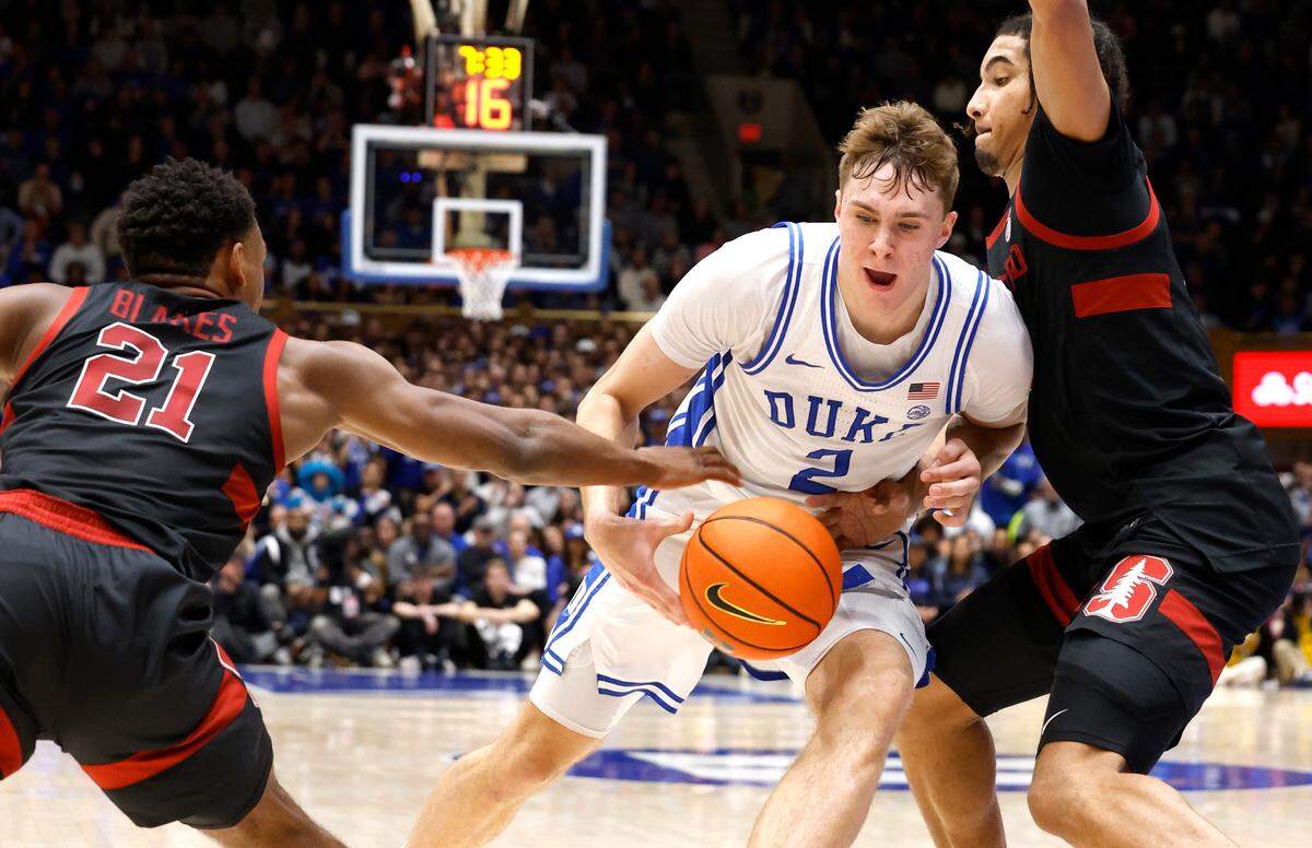 Duke’s Cooper Flagg (2) drives past Stanford’s Jaylen Blakes (21) and Donavin Young (2) during the first half of Duke’s game against Stanford at Cameron Indoor Stadium in Durham, N.C., Saturday, Feb. 15, 2025.