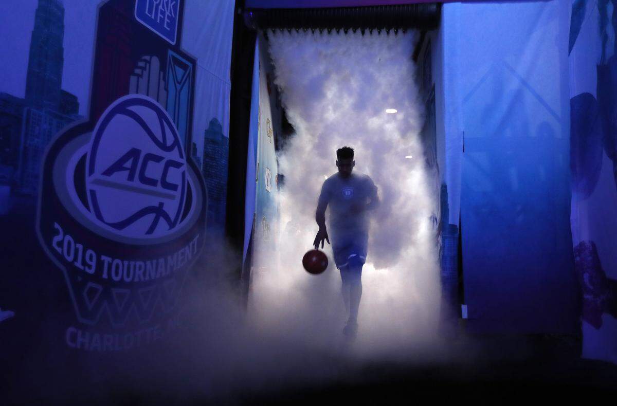 Duke's Javin DeLaurier (12) leads the team onto the court before Duke's game against UNC in the semifinals of the 2019 ACC Tournament in Charlotte, N.C., Friday, March 15, 2019.