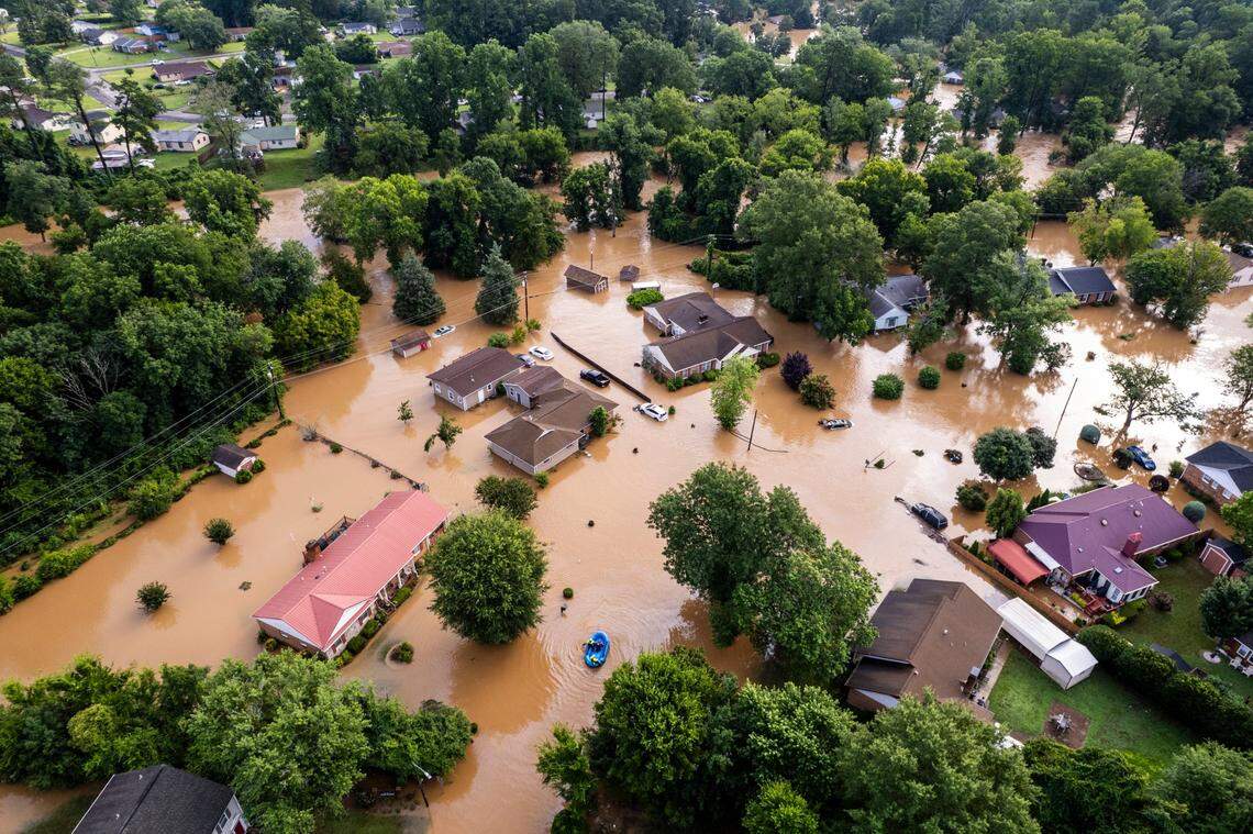 A water rescue unit paddles a raft in the Old Farm neighborhood along the Eno River in Durham on Monday morning, July 7, 2025, after Tropical Storm Chantal caused flash flooding.