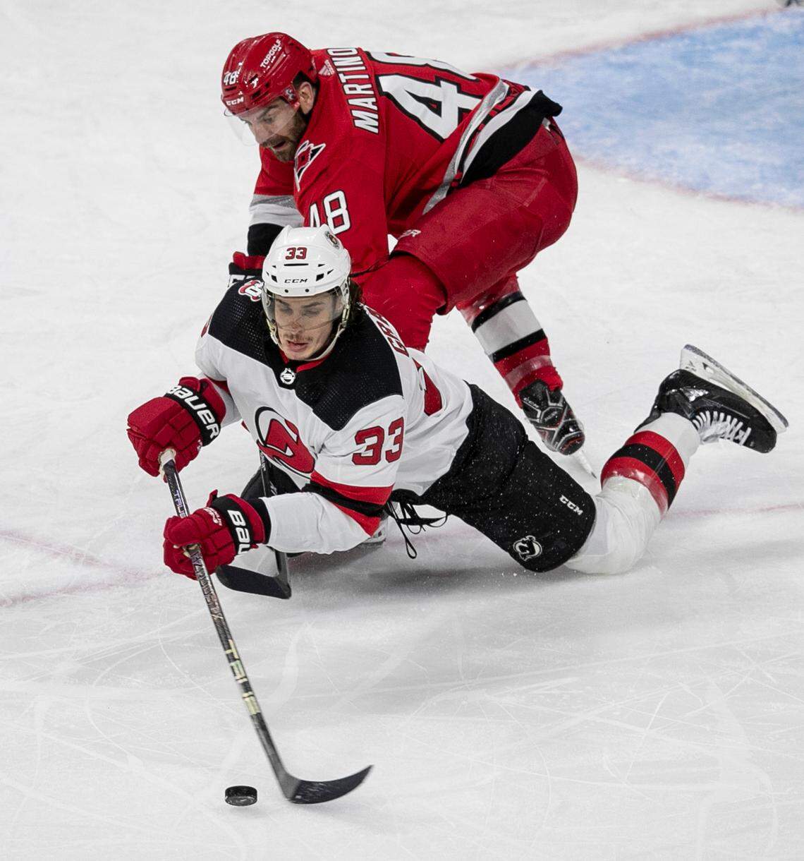 The Carolina Hurricanes Jordan Martinook (48) checks the New Jersey Devils Ryan Graves (33) in the second period during Game 2 of their second round Stanley Cup playoff series on Friday, May 5, 2023 at PNC Arena in Raleigh, N.C.