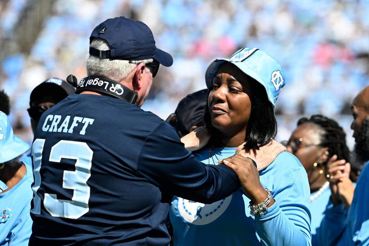 North Carolina Tar Heels head coach Mack Brown and September Craft during an Oct. 12 tribute to former player Tylee Craft who died of lung cancer.