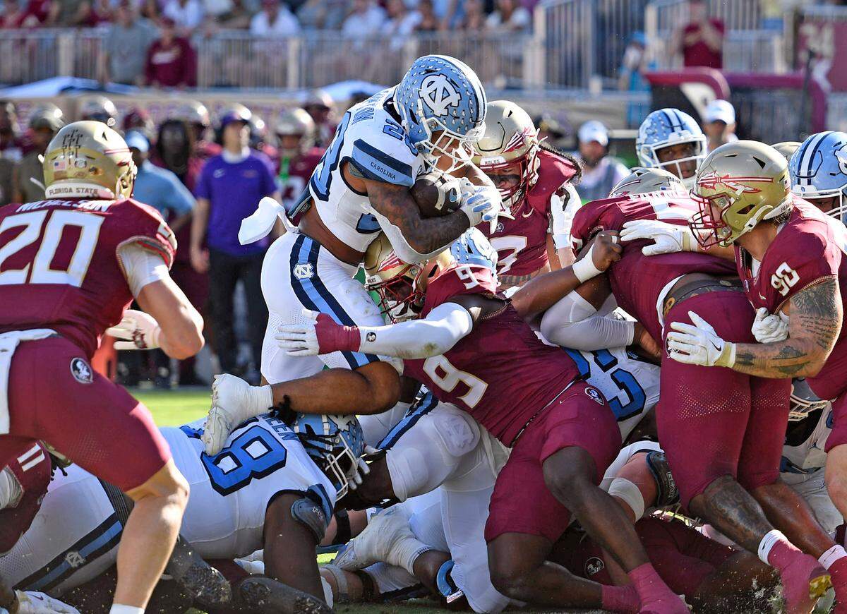 Nov 2, 2024; Tallahassee, Florida, USA; North Carolina Tarheels running back Omarian Hampton (28) is stopped by the Florida State Seminoles defense at the goal line during the first half at Doak S. Campbell Stadium. Mandatory Credit: Robert Myers-Imagn Images