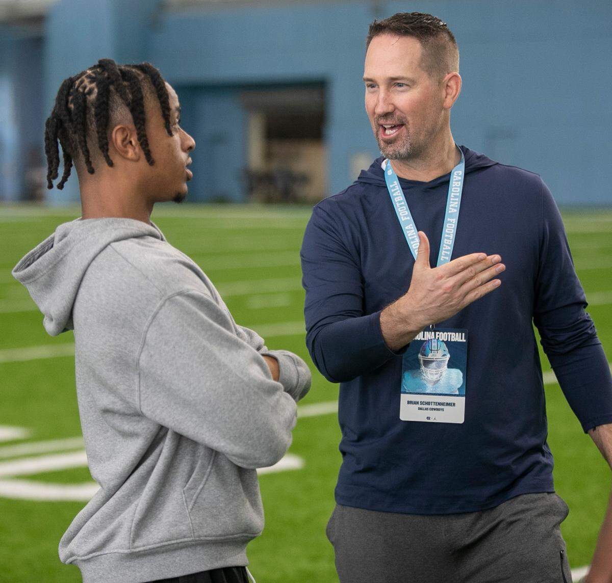 Brian Schottenheimer with the Dallas Cowboys talks with North Carolina’s Josh Downs following his workout during the NFL Pro Day on Monday, March 27, 2023 in Chapel Hill, N.C.