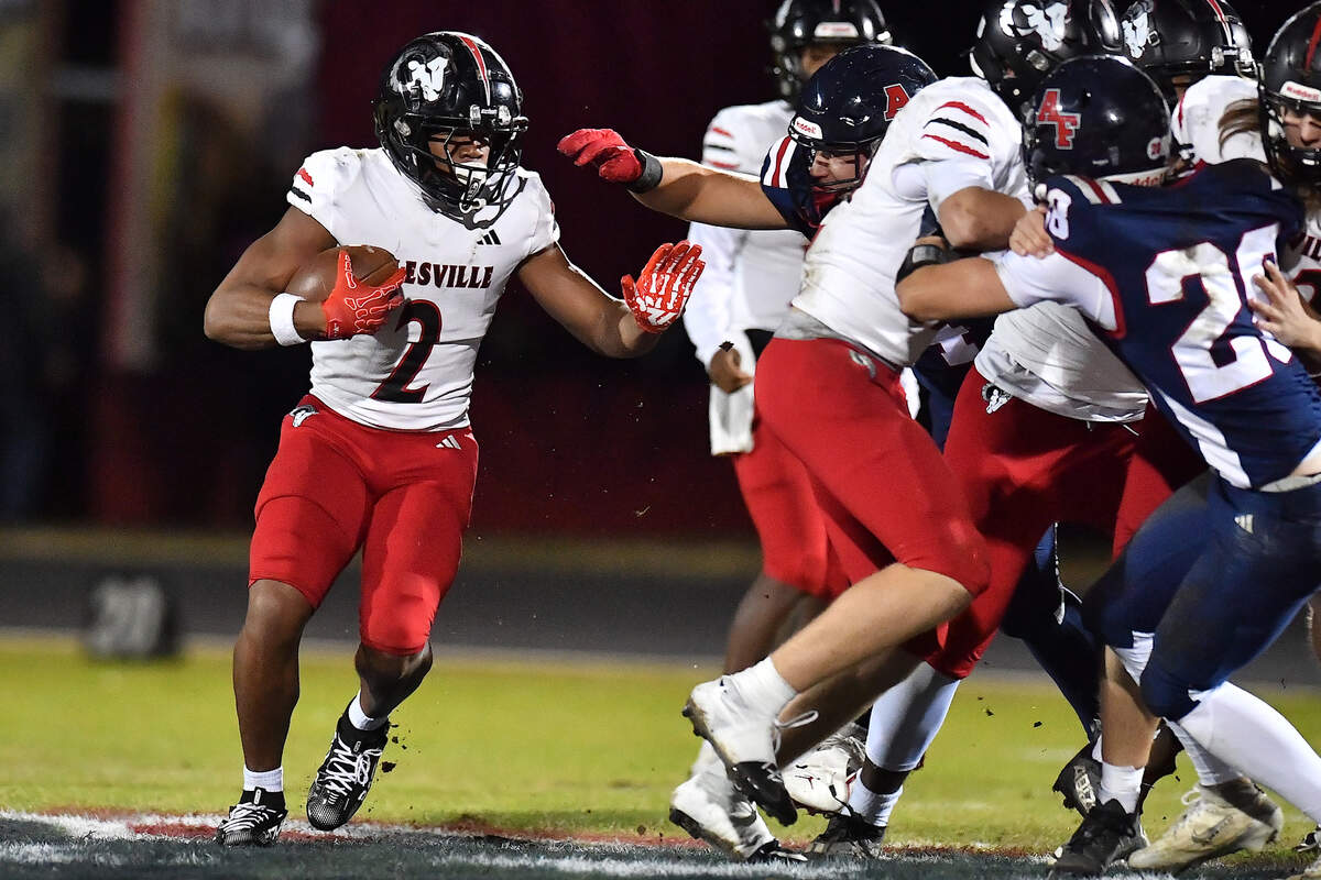 Rolesville running back Amir Brown (2) looks for an opening to rush against Apex Friendship during the first half. The Apex Friendship Patriots and the Rolesville Rams met in  the second round of the  NCHSAA 8A Playoff game in Apex, N.C. on November 14, 2025. Rolesville wins 14-7 in overtime.