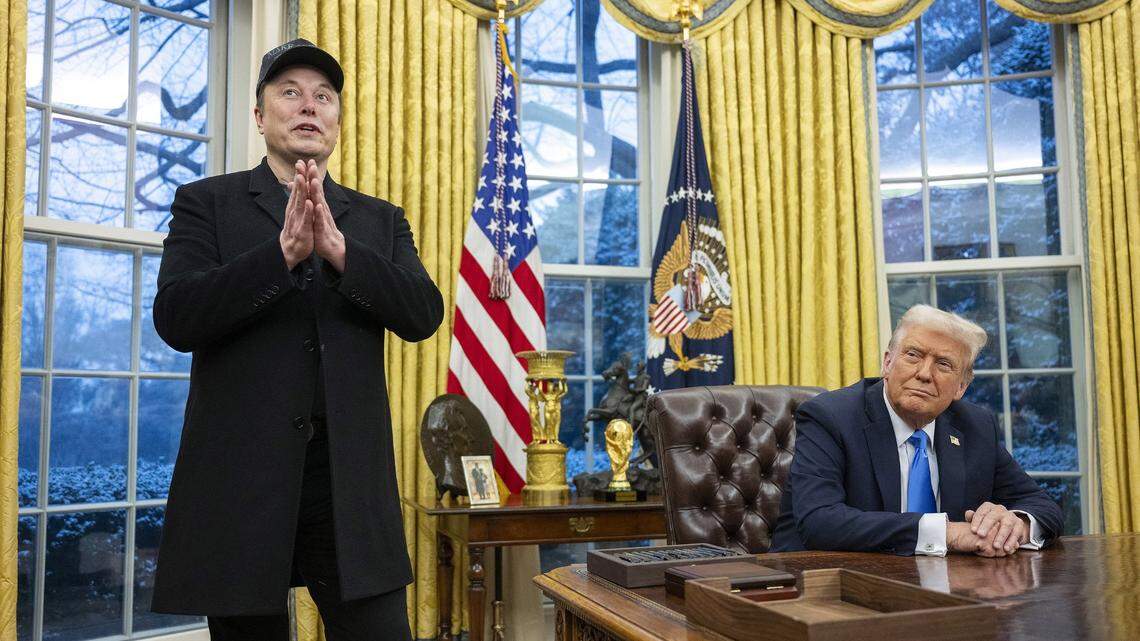 Elon Musk speaks as President Donald Trump looks on in the Oval Office of the White House in Washington, D.C., on Feb. 11, 2025.
