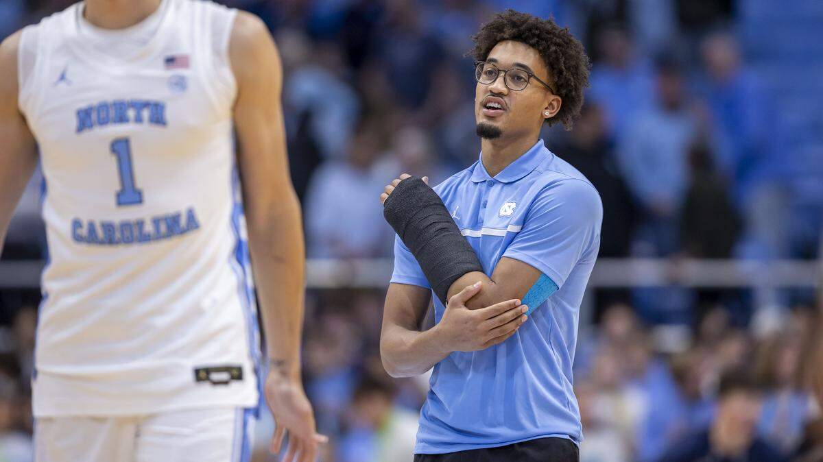 North Carolina guard Seth Trimble, out after breaking a bone in his left arm, encourages his teammates, including forward Zayden High (1), during the Tar Heels’ pre-game warm ups ahead of their game against Navy on Tuesday, November 18, 2025 at the Smith Center in Chapel Hill, N.C.