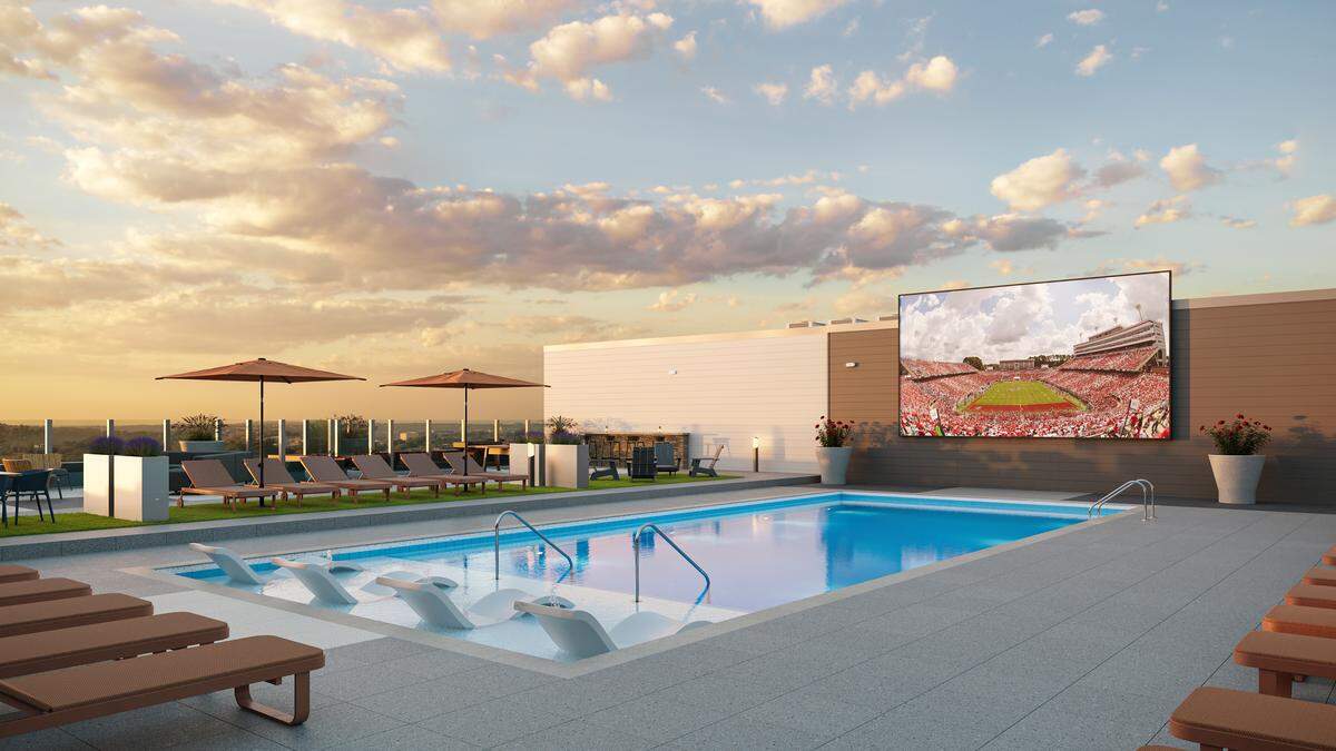 A rendering of a rooftop pool with “Jumbotron”-video screen at Signature at Varsity near NC State in Raleigh.
