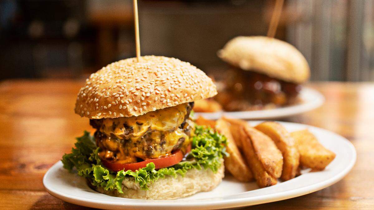 The Station Burger, foreground, and the Texas Burger are both served with potato wedges at The Station in Raleigh. The popular restaurant will close March 8 to make way for a new concept from the Hibernian Group. 