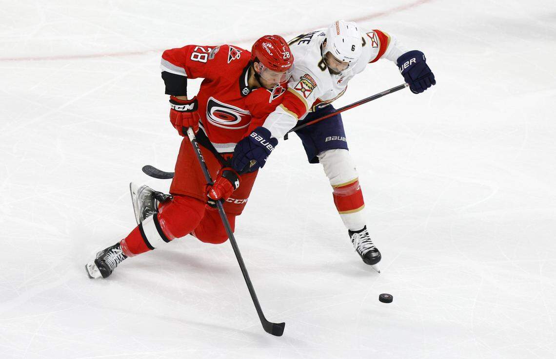 Carolina left wing Mackenzie MacEachern (28) brings the puck around Florida center Colin White (6) during the first period of game two between the Hurricanes and Panthers in the Eastern Conference Finals at PNC Arena in Raleigh, N.C., Saturday, May 20, 2023.