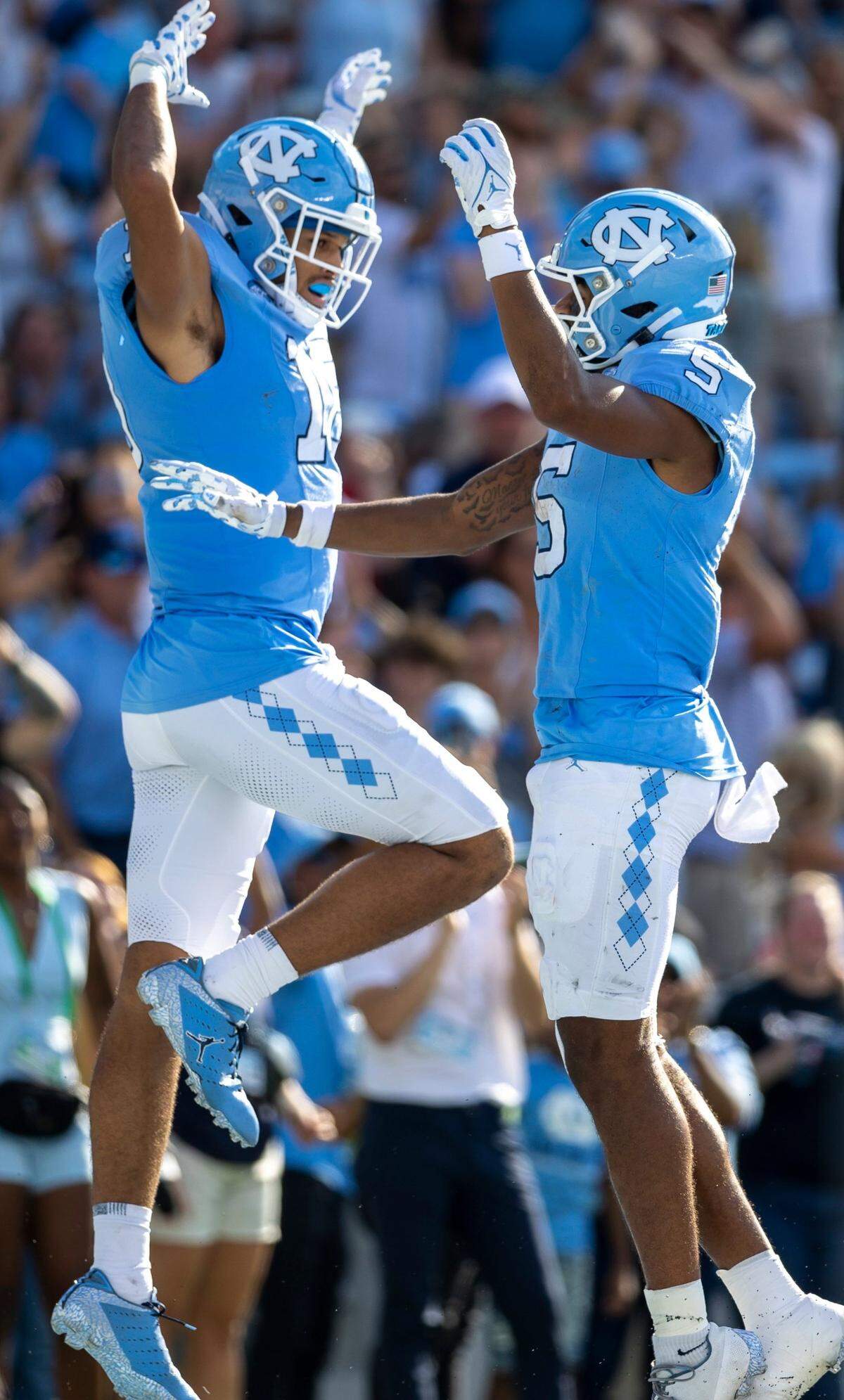 North Carolina’s Bryson Nesbit (18) celebrates with teammate J.J. Jones (5) after scoring a touchdown on a 19-yard pass reception from quarterback Drake Maye to give the Tar Heels a 21-3 lead over Minnesota on Saturday, September 16, 2023 at Kenan Stadium in Chapel Hill N.C.