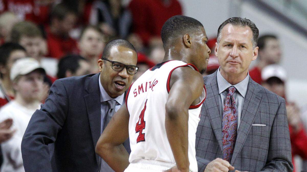 N.C. State assistant coach Orlando Early, left, and head coach Mark Gottfried talk with Dennis Smith Jr. during the Wolfpack’s game against Wake Forest at PNC Arena in Raleigh, N.C., Saturday, Jan. 21, 2017.