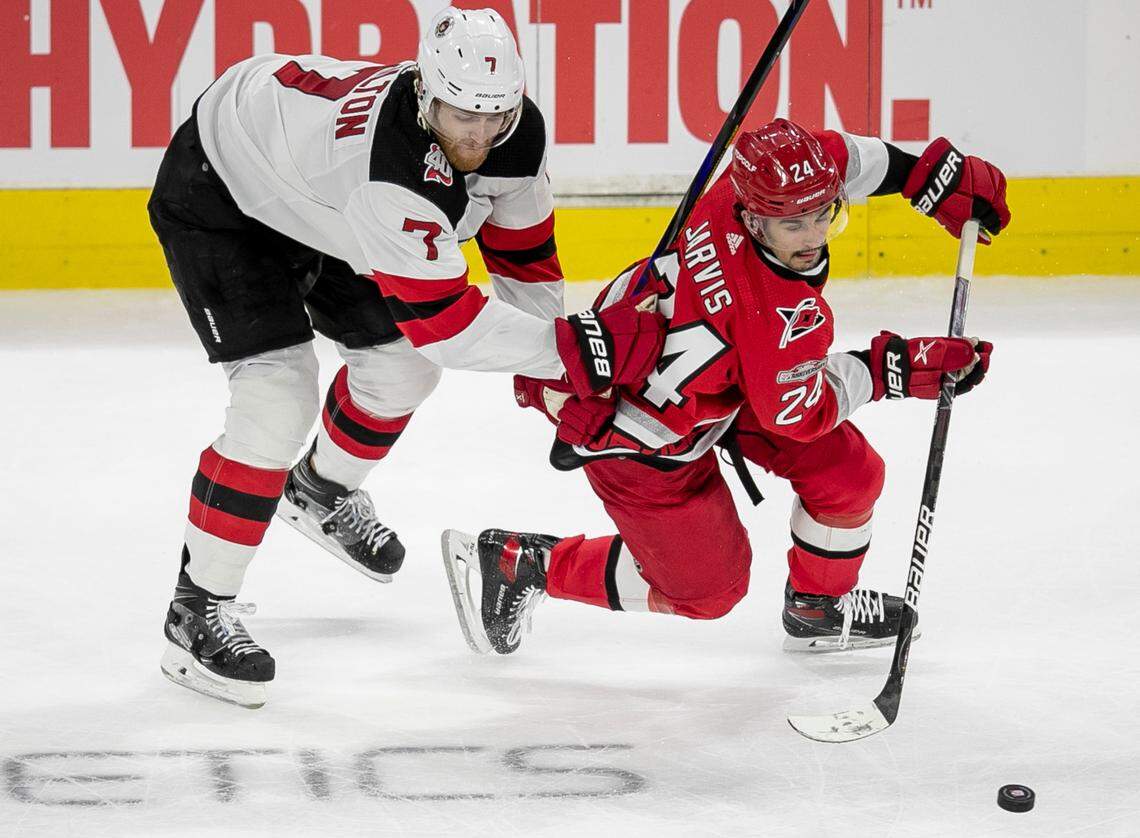 The Carolina Hurricanes Seth Jarvis (24) controls the puck ahead of New Jersey Devils Dougie Hamilton (7) in the second period during Game 1 of their second round Stanley Cup playoff series against the New Jersey Devils on Wednesday, May 3, 2023 at PNC Arena in Raleigh, N.C.