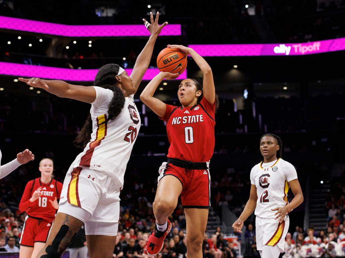 N.C. State’s Devyn Quigley shoots over South Carolina’s Sania Feagin during the first half of the Wolfpack’s game on Sunday, Nov. 10, 2024, at Spectrum Center in Charlotte, N.C.