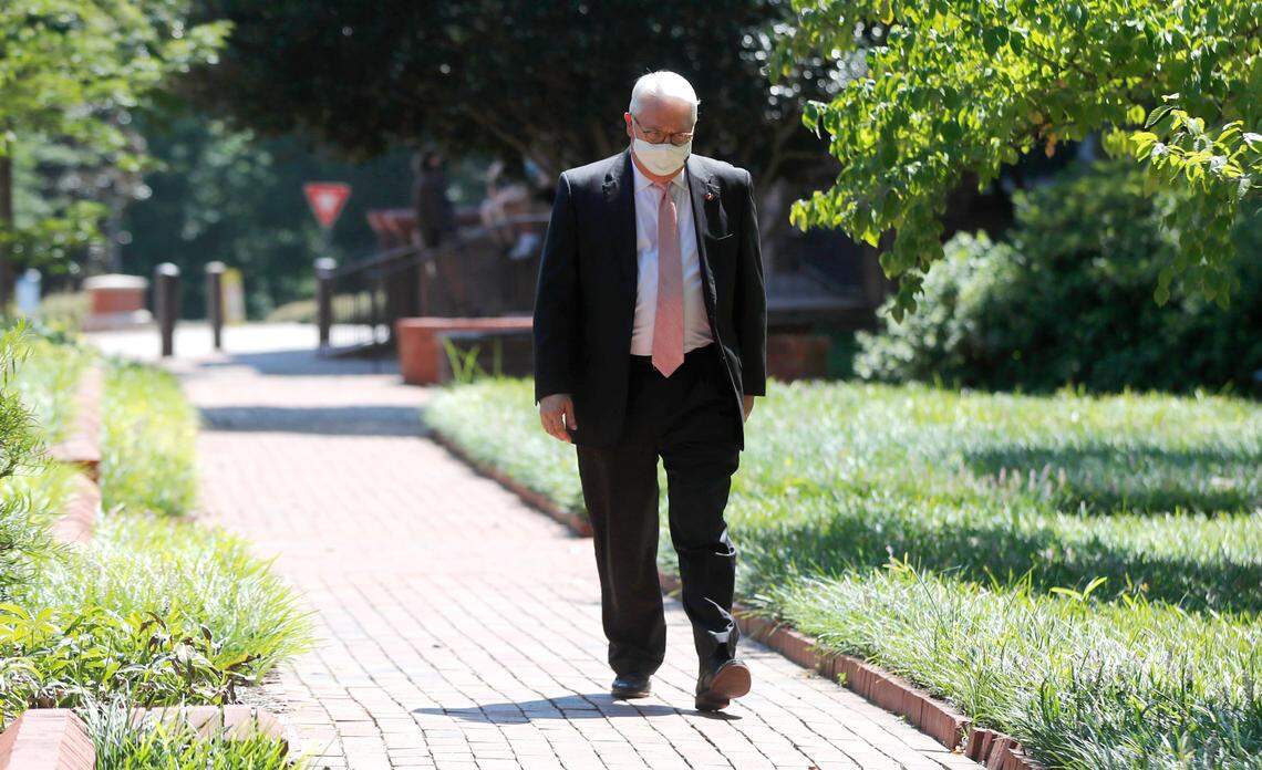 N.C. State Chancellor Randy Woodson walks towards the gathered press to talk about the decision to close dorms at N.C. State University in Raleigh, N.C. Wednesday, August 26, 2020.