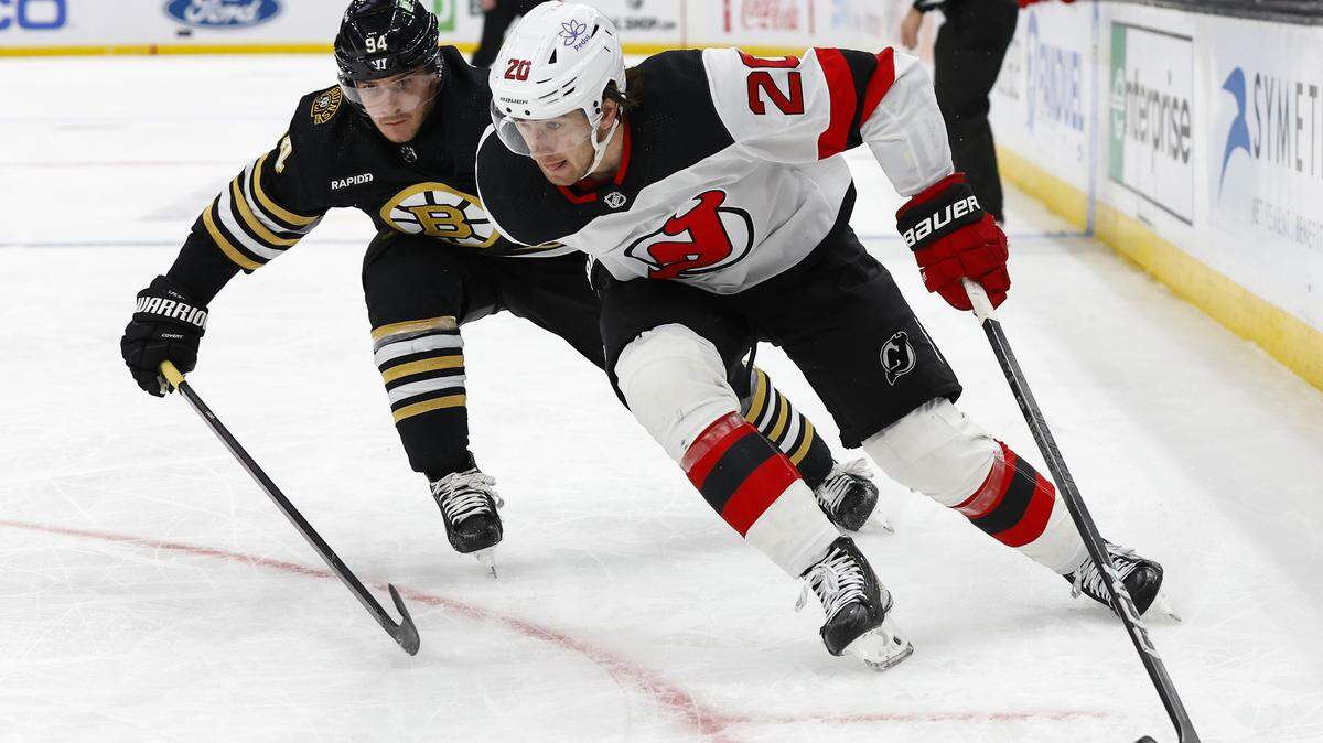 Jan 15, 2024; Boston, Massachusetts, USA; New Jersey Devils center Michael McLeod (20) tries to hold off Boston Bruins center Jakub Lauko (94) during the second period at TD Garden. Mandatory Credit: Winslow Townson-USA TODAY Sports