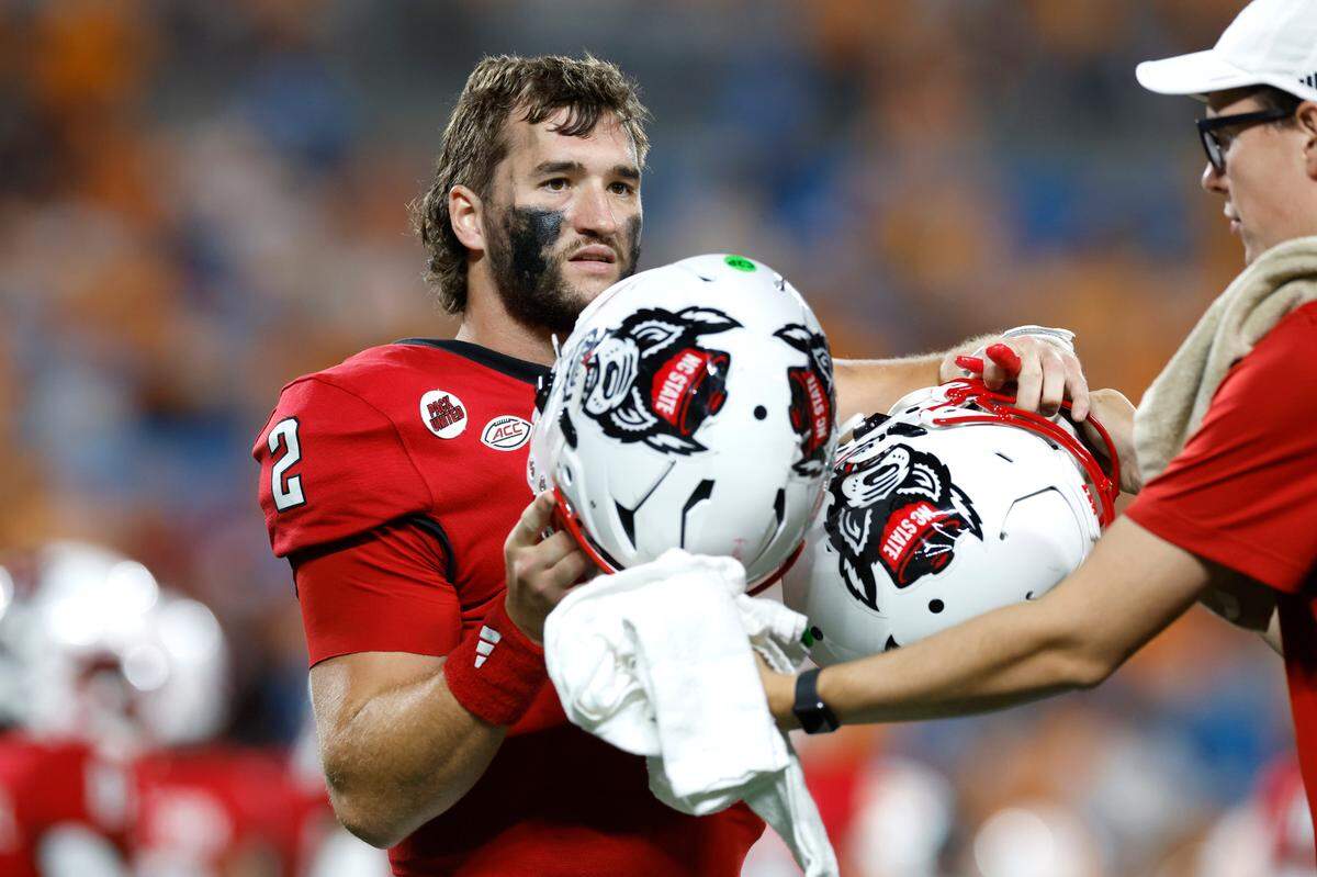 N.C. State quarterback Grayson McCall (2) switches helmets during the second half of Tennessee’s 51-10 victory over N.C. State in the Duke’s Mayo Classic at Bank of America Stadium in Charlotte, N.C., Saturday, Sept. 7, 2024.